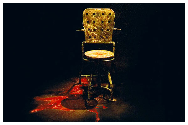 The iconic chair from hostel, with blood on the floor.